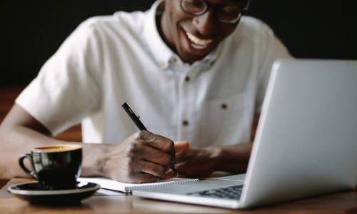 Person working at their computer with coffee
